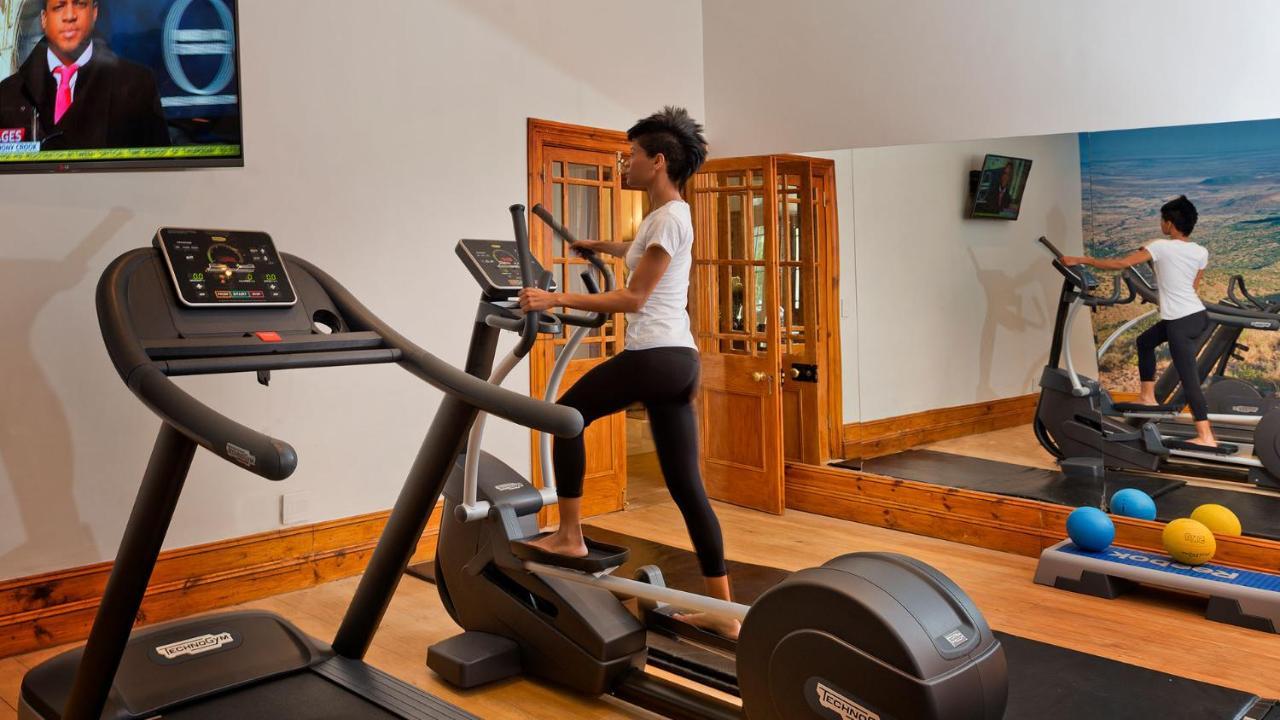Drostdy Hotel Graaff Reinet Bagian luar foto A woman using a cross trainer