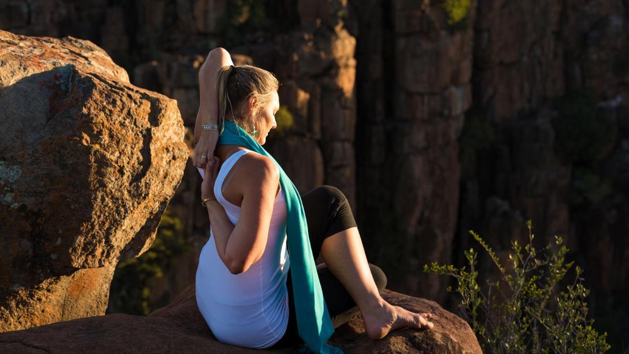 Drostdy Hotel Graaff Reinet Bagian luar foto A woman practicing yoga